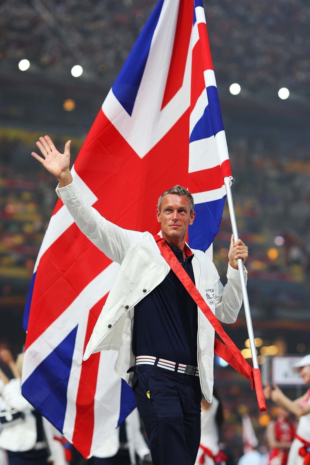 Mark Foster carrying the British flag at the Beijing 2008 Olympic opening ceremony